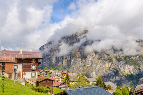 Beautiful Swiss mountain valley landscape with a house roof.