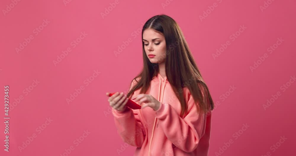 A woman looks at the phone, leafs through a smartphone and is sad A woman looks at the phone, leafs through a smartphone and is sad