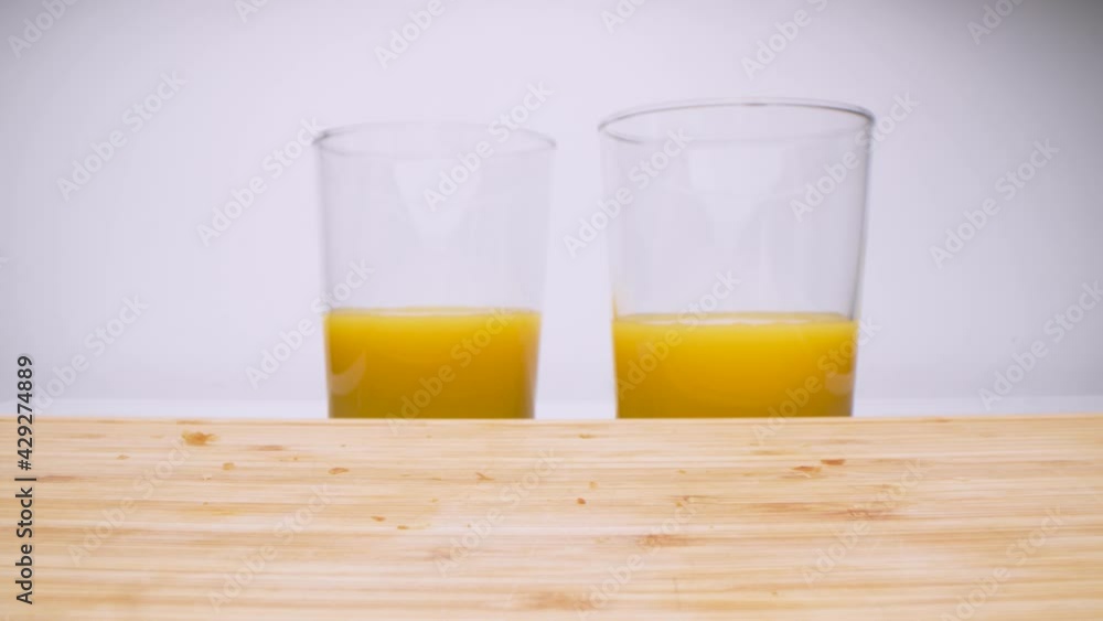 Super close up shot of couple taking the last croissant and splitting it in two parts. Breakfast routine. Orange juice in the background. Super close up shot of couple taking the last croissant and splitting it in two parts. Breakfast routine. Orange juice in the background.