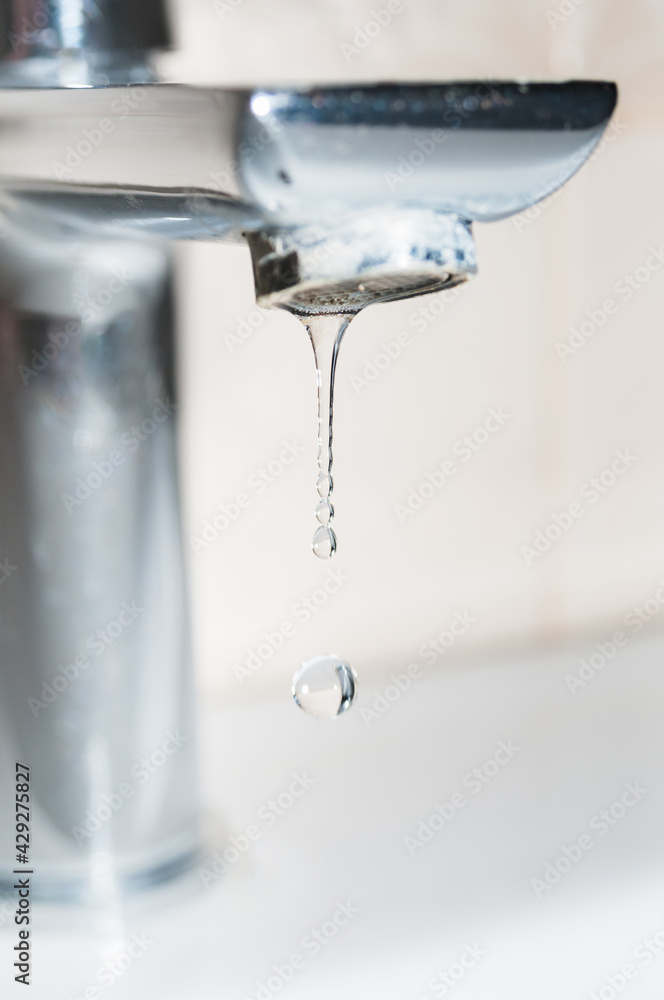 Metal faucet and water drops close up Metal faucet and water drops close up
