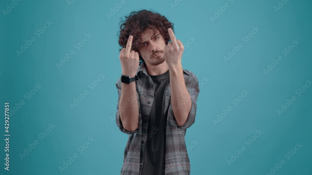The serious, angry young man shows with both hands fuck you. Isolated on black background, Concept of life. People's emotions. 4k portrait The serious, angry young man shows with both hands fuck you. Isolated on black background, Concept of life. People's emotions. 4k portrait