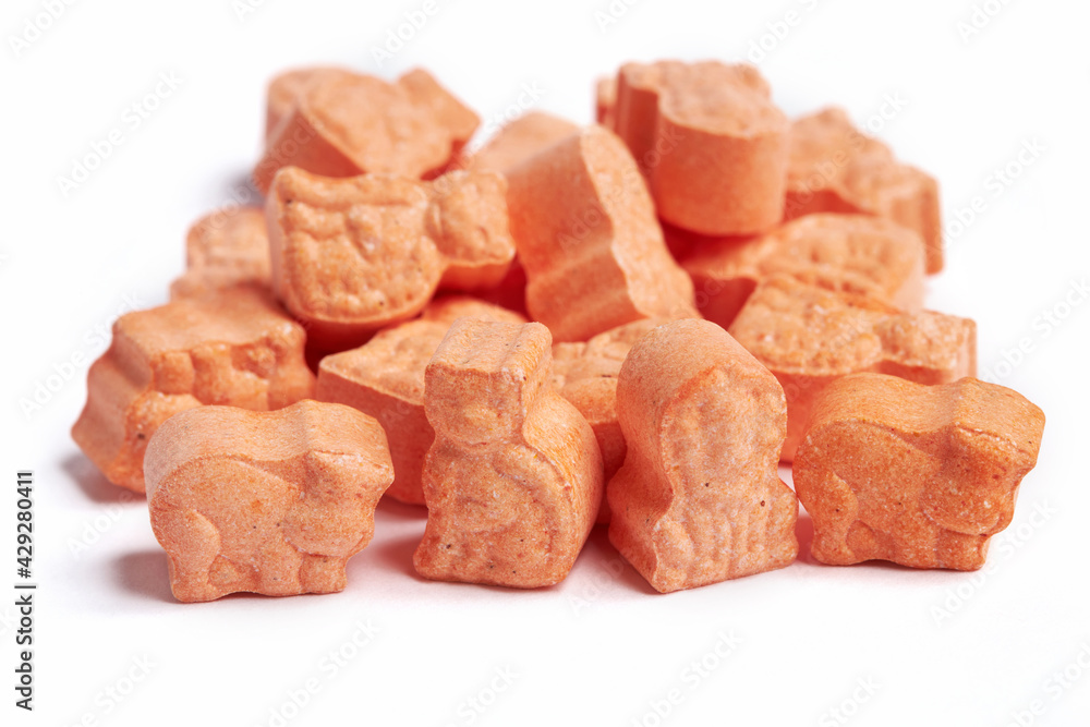 Orange animal shape vitamins for kids isolated on a white background. Assorted animal shaped multivitamins for kids. Chewable pills Orange animal shape vitamins for kids isolated on a white background. Assorted animal shaped multivitamins for kids. Chewable pills