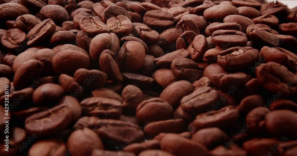 Coffee Beans On Rotating Surface Closeup Coffee Beans On Rotating Surface Closeup