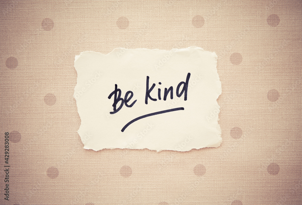 Be kind - black calligraphy lettering on card with dots, motivation phrase 