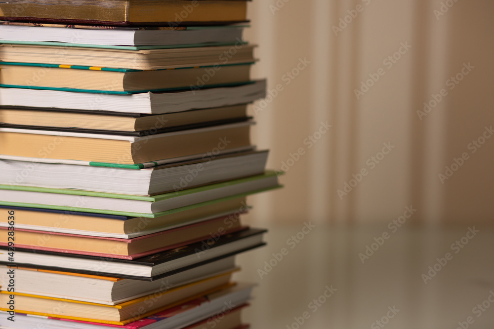 Pile of books on a desk at home Pile of books on a desk at home
