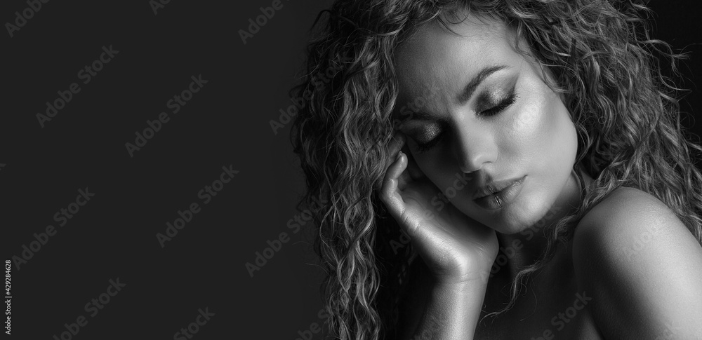 Lovely sad woman with curly hair and glowing skin Lovely sad woman with curly hair and glowing skin