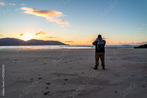 Man standing at Kiltoorish bay beach between Ardara and Portnoo in Donegal - Ireland. © Lukassek
