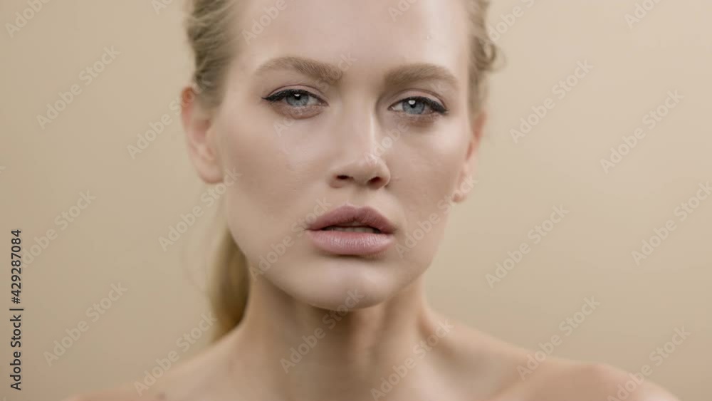 Model Posing In Front Of The Camera. Face Of Blonde Girl With Serious Expression. Face Close Up. Model Posing In Front Of The Camera. Face Of Blonde Girl With Serious Expression. Face Close Up.