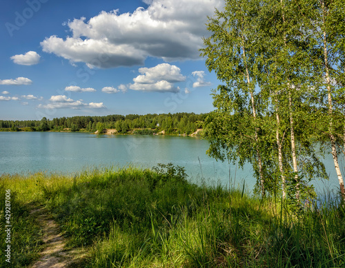 Summer vacation on the banks of an old quarry with turquoise water.