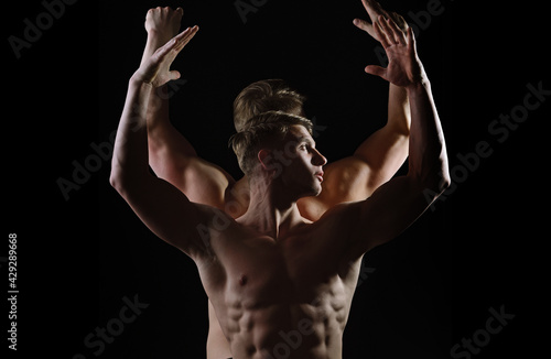 Strong athletic men, fit male models. Sexy muscular men with bare naked body torso. Man naked torso in underwear with athletic body on black background.