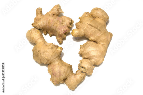 Fresh ginger rhizome. Ginger is laid out in the shape of a heart. Isolated on white background.