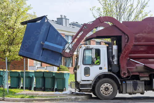 Red truck with a loading household container home maintenance public services