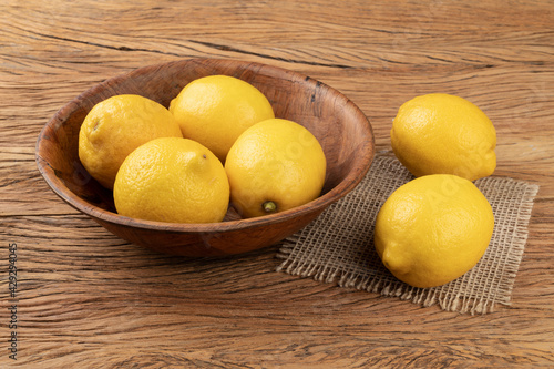 Sicilian lemons in a bowl over wooden table
