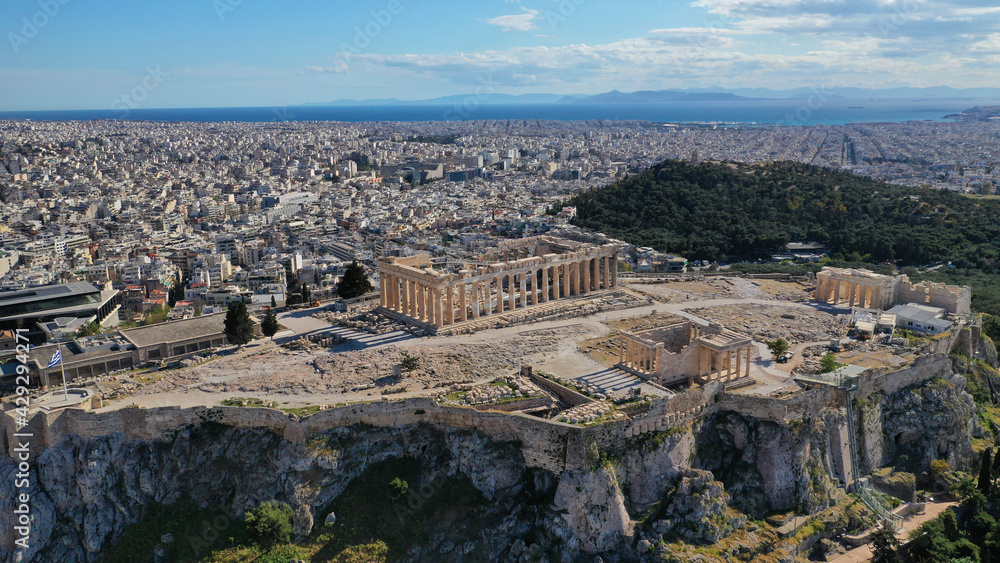 Aerial drone photo of one of the wonders of Ancient world, Acropolis hill and the Parthenon with great views to Plaka district and whole urban Athens, Attica, Greece