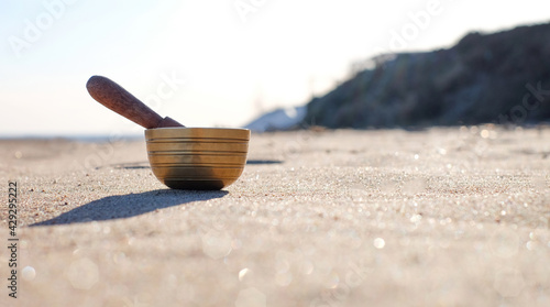 Himalayan tibetian singing bowl on sand natural background. Harmony and relaxation concept, with copy space