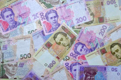 Many Ukrainian money bills of various denominations and colors   Modern Ukrainian money - hryvnia. UAH. Money background