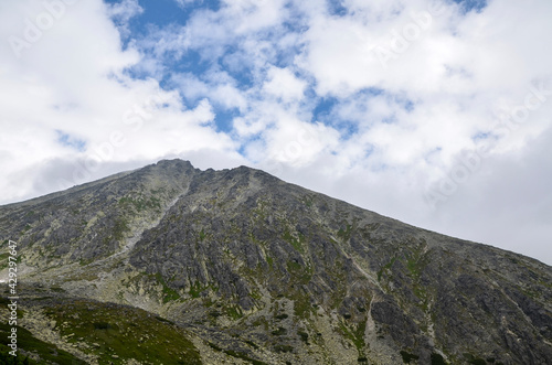 Beautiful sharp mountain peaks in summer time in National Park High Tatras with cloudy sky.