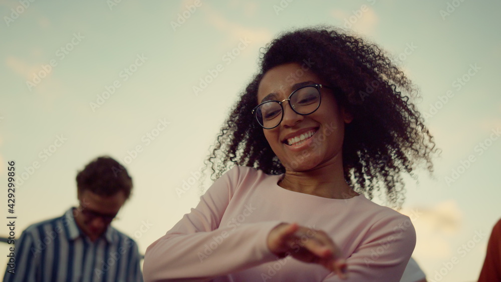 African woman spending great time at party. Portrait afro girl dancing outdoors African woman spending great time at party. Portrait afro girl dancing outdoors