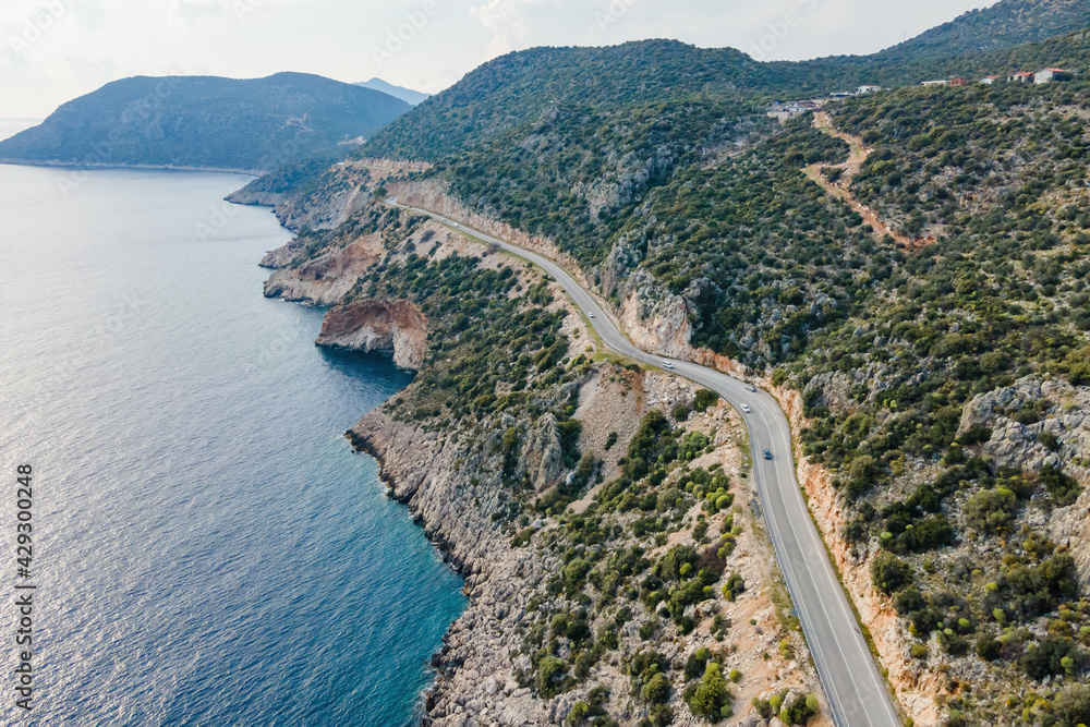 Aerial view of curves coastline road alonge sea. Summer time road trip to sea by car on coast Highway