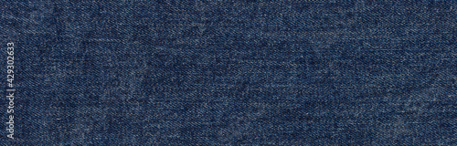 texture of dark blue jeans denim fabric background 