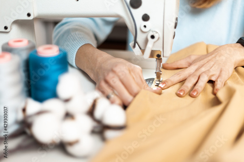 Clothing repair. Worker in a garment factory, fashionable and sustainable production. Fix dress.