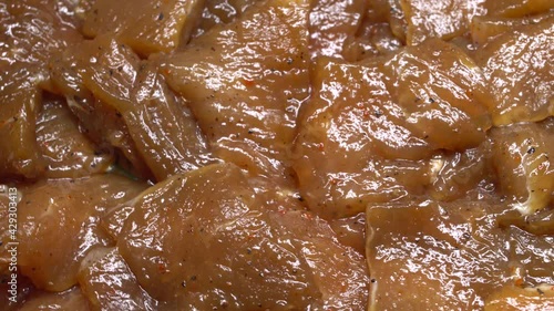 Thinly cut, skinless raw chicken meat ready for a stir-fry. Uncooked, marinated in soy sauce and spices.
Chinese food. Close up. Food background.
Rotation.