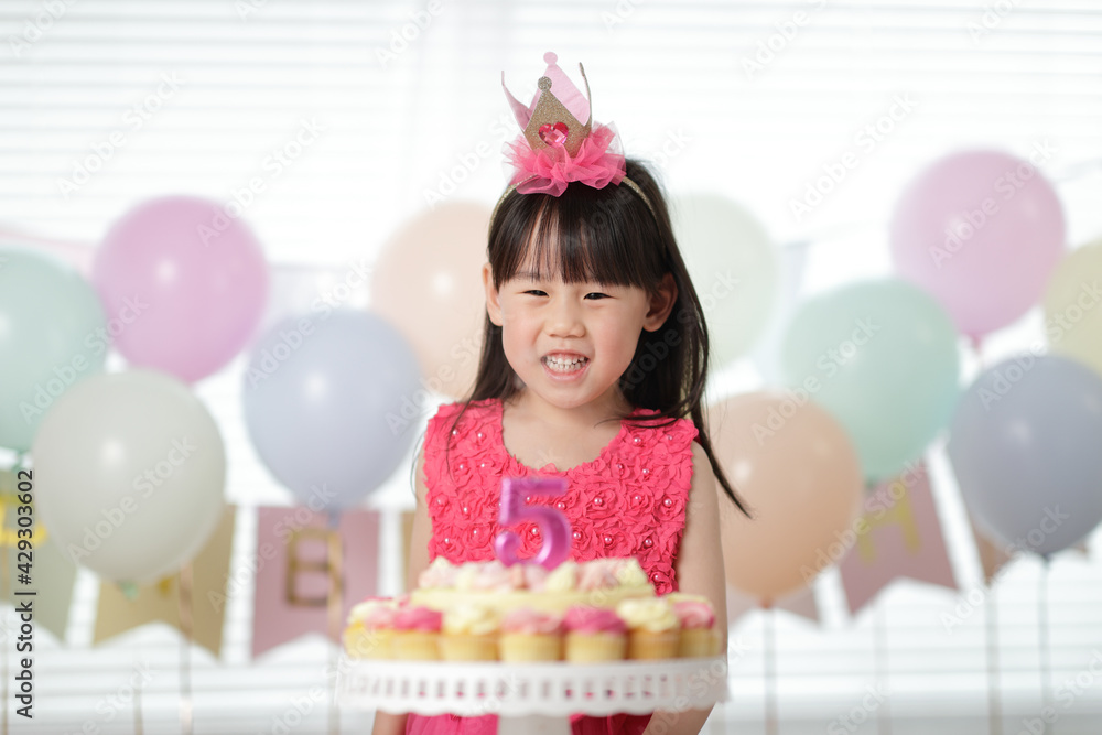 young girl celebrating her 5th birthday at home young girl celebrating her 5th birthday at home