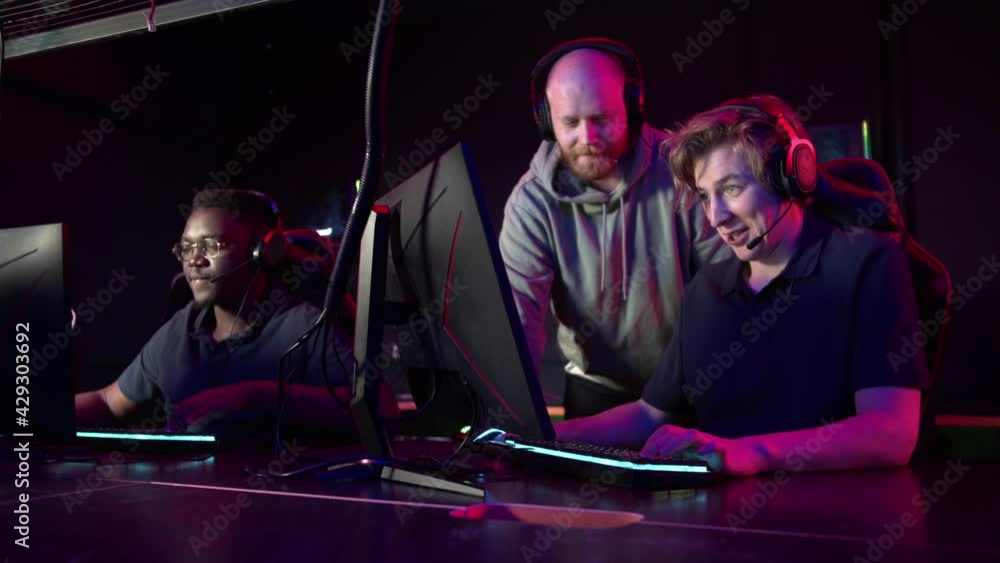 During a computer games tournament, a young guy is nervous, the coach tells him the tactics of the fight During a computer games tournament, a young guy is nervous, the coach tells him the tactics of the fight