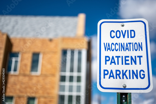 COVID vaccination site with sign and empty parking