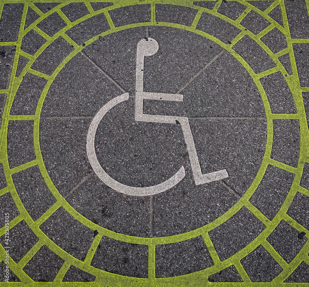 Kelly green handicap symbol in stone signage
