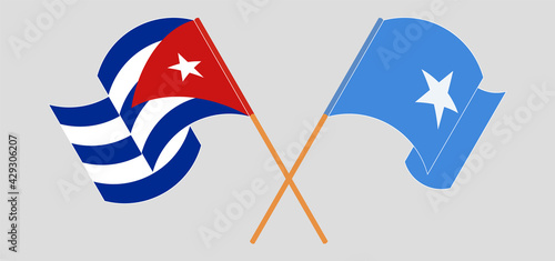 Crossed and waving flags of Cuba and Somalia