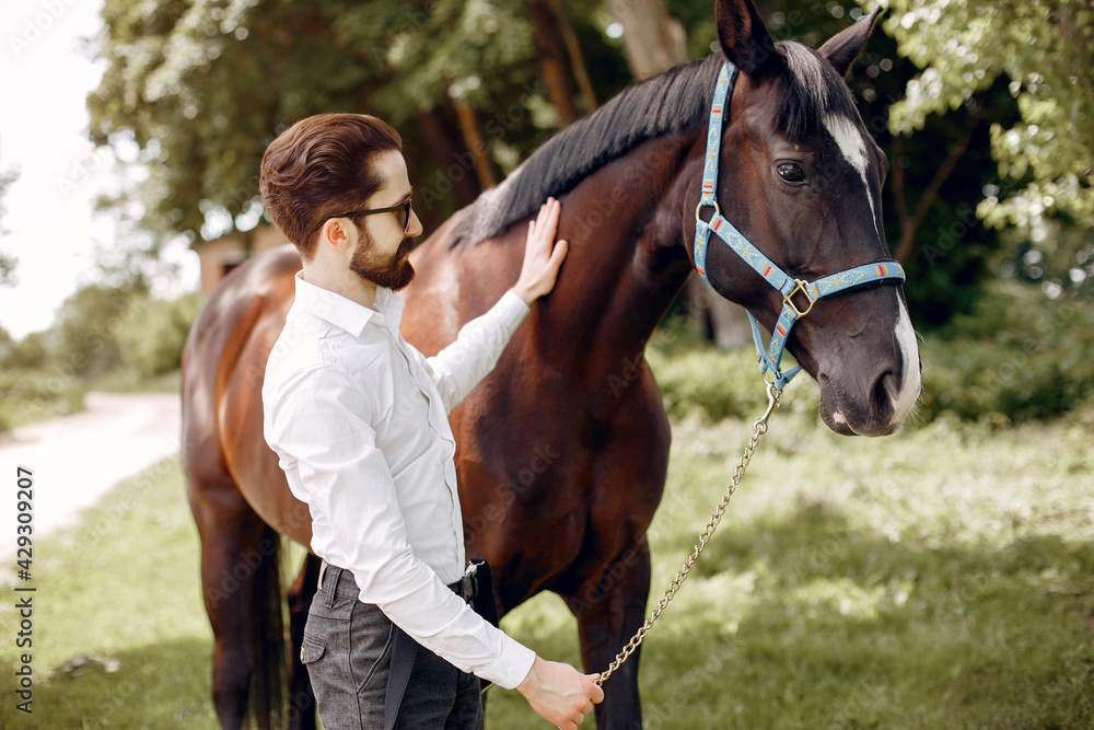 Obraz premium Handsme man standing in a ranch