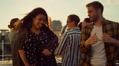 Energy couple having fun at disco. Happy people partying in sunset light.