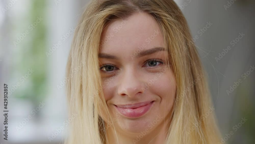 Headshot of charming young woman taking off VR headset looking at camera smiling. Close-up portrait of happy carefree Caucasian lady posing at home indoors after gaming online. Modern lifestyle Headshot of charming young woman taking off VR headset looking at camera smiling. Close-up portrait of happy carefree Caucasian lady posing at home indoors after gaming online. Modern lifestyle