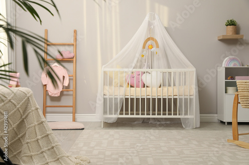 Fototapeta Naklejka Na Ścianę i Meble -  Cozy baby room with crib and other furniture. Interior design