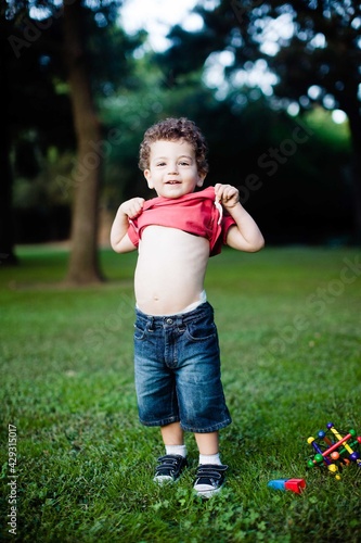 Little Boy Shows Belly in Park