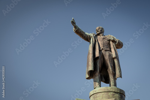 The leader of the world proletariat, Vladimir Ilyich Lenin. Monument in the city of St. Petersburg. A sculpture of a man with an outstretched hand against a blue sky. Spring day.