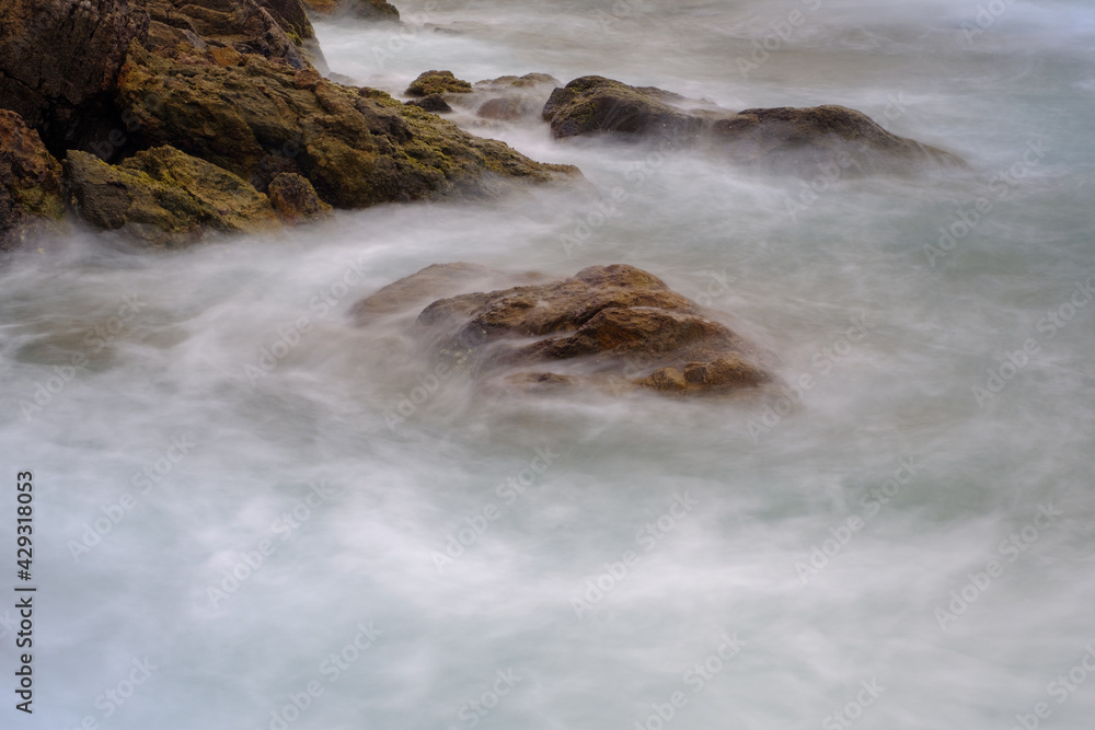 Waves crashing over the rock in the South China Sea close to Tai Long Wan beach in Eastern Sai Kung - a very popular destination among the surfing community in Hong Kong Waves crashing over the rock in the South China Sea close to Tai Long Wan beach in Eastern Sai Kung - a very popular destination among the surfing community in Hong Kong
