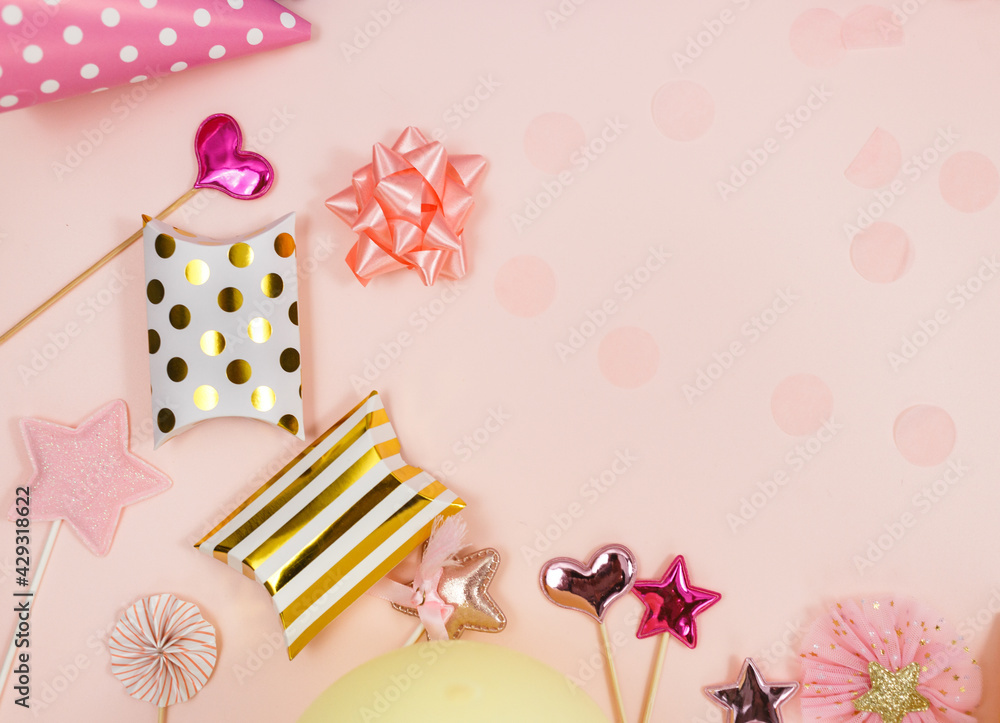 Background for happy birthday celebration or party. Group of colored balloons , confetti, candles, ribbons on pastel pink background. Mock up with copy space, place for text	