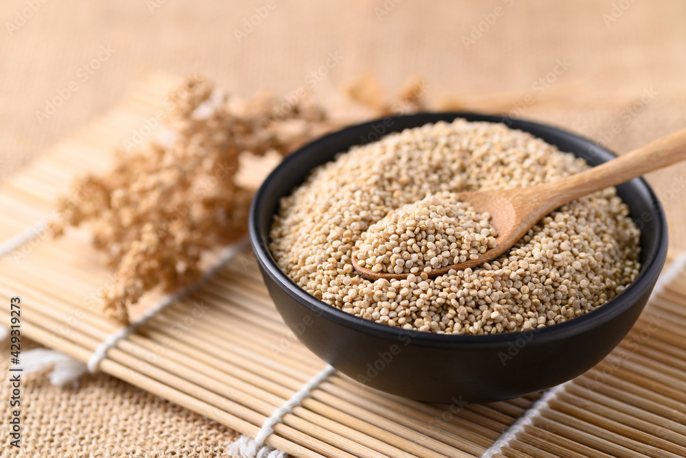 Brown quinoa seeds in a bowl with spoon, Edible seeds are high protein, Healthy food Brown quinoa seeds in a bowl with spoon, Edible seeds are high protein, Healthy food