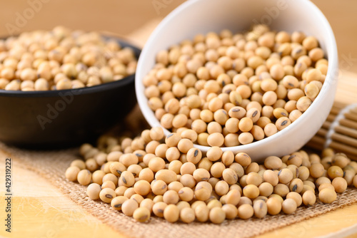 Soybean seeds in a bowl on wooden background