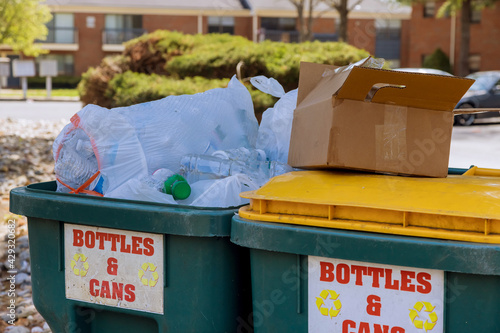 Garbage containers near apartment building in district garbage bins to help separate recycle