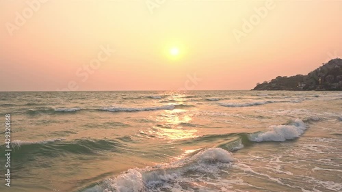 Exotic view of the sunset over the sea, slow-motion  of sea waves foamy slowly rolling towards the beach on Marmaris Turkey  photo