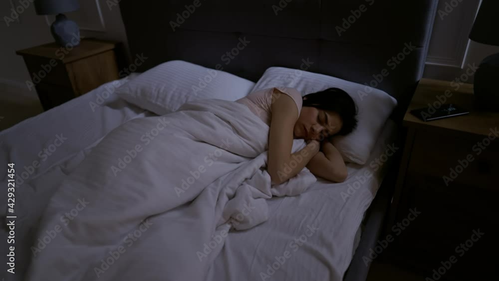 The girl has insomnia, she is spinning in bed, she cannot sleep. She picks up her smartphone, tries to go back to sleep, but to no effect. The girl has insomnia, she is spinning in bed, she cannot sleep. She picks up her smartphone, tries to go back to sleep, but to no effect.