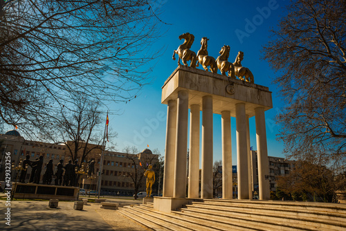 SKOPJE, NORTH MACEDONIA: Golden winged goddess woman holding wreath, four golden horses standing on rear legs and Prometheus holding a burning torch. photo