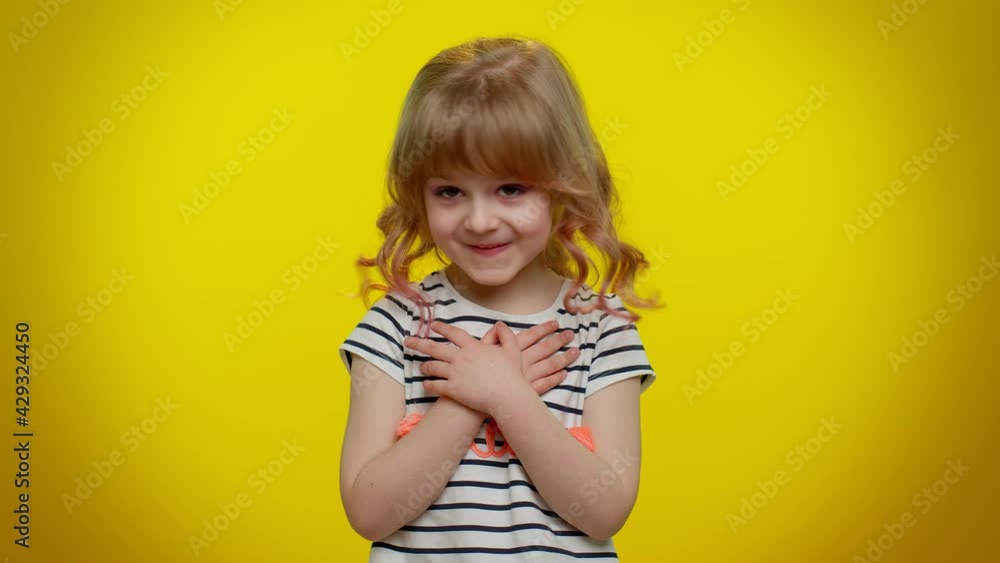 I am not guilty. Portrait of blonde kid child 5-6 years old pointing fingers himself ask say who me no thanks i do not need it. Yellow studio wall background. Teenager children girl lifestyle emotions
