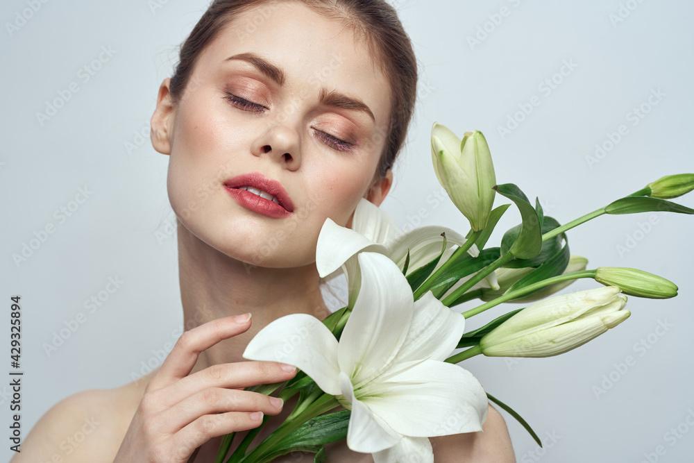 woman with white flowers on gray background portrait close-up makeup mode woman with white flowers on gray background portrait close-up makeup mode