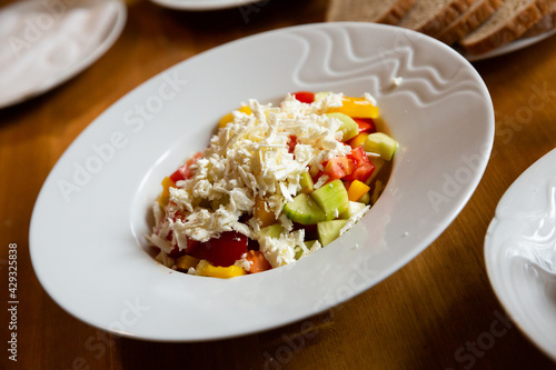 Popular czech Shopska salad with fresh vegetables and soft cheese
