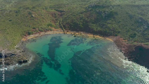 Crystal Clear Water Cala Rotja Near Cavalleria Beach At Daytime In Balearic Islands, Spain. - aerial photo