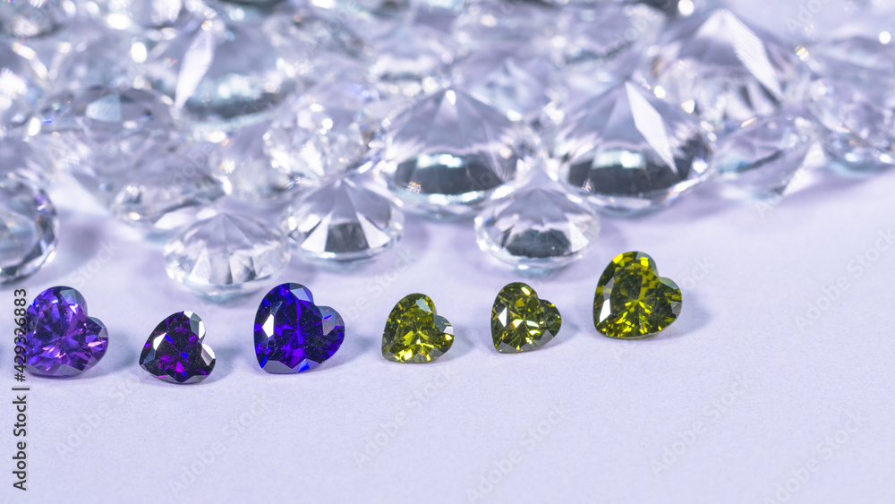 colorful diamond in heart shape are placed in a row on white diamonds background, colorful diamond in heart shape are placed in a row on white diamonds background,